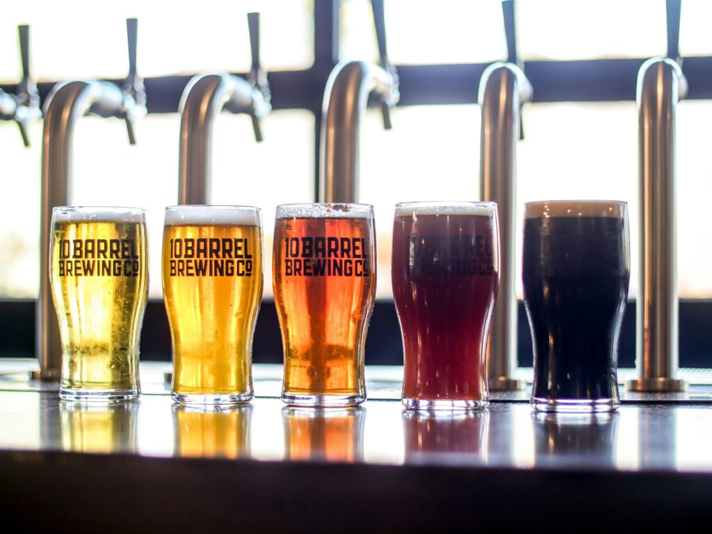Various craft beers from 10 Barrel Brewing Co. lined up in a pub setting.